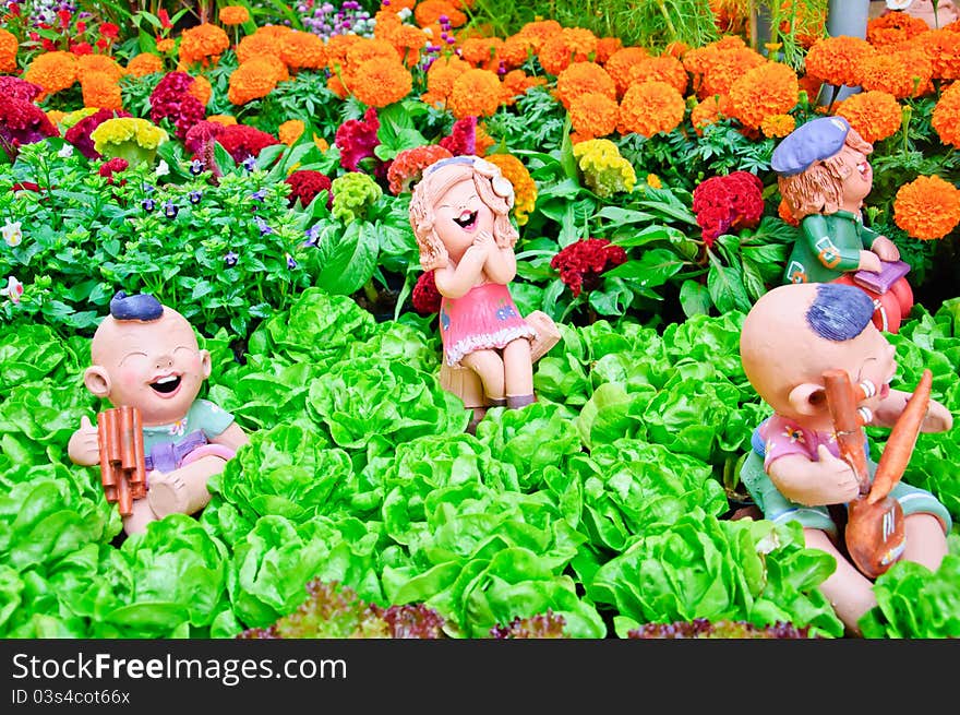 A girl and 2 boys doll play music in the garden. A girl and 2 boys doll play music in the garden