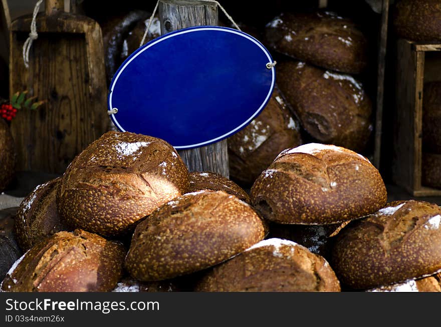 Fresh bread on a market with an empty blue sign