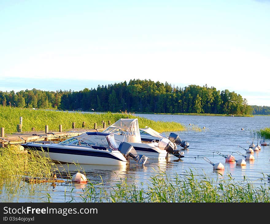 Boats at bay, at the pier, at summer, blue sky and water