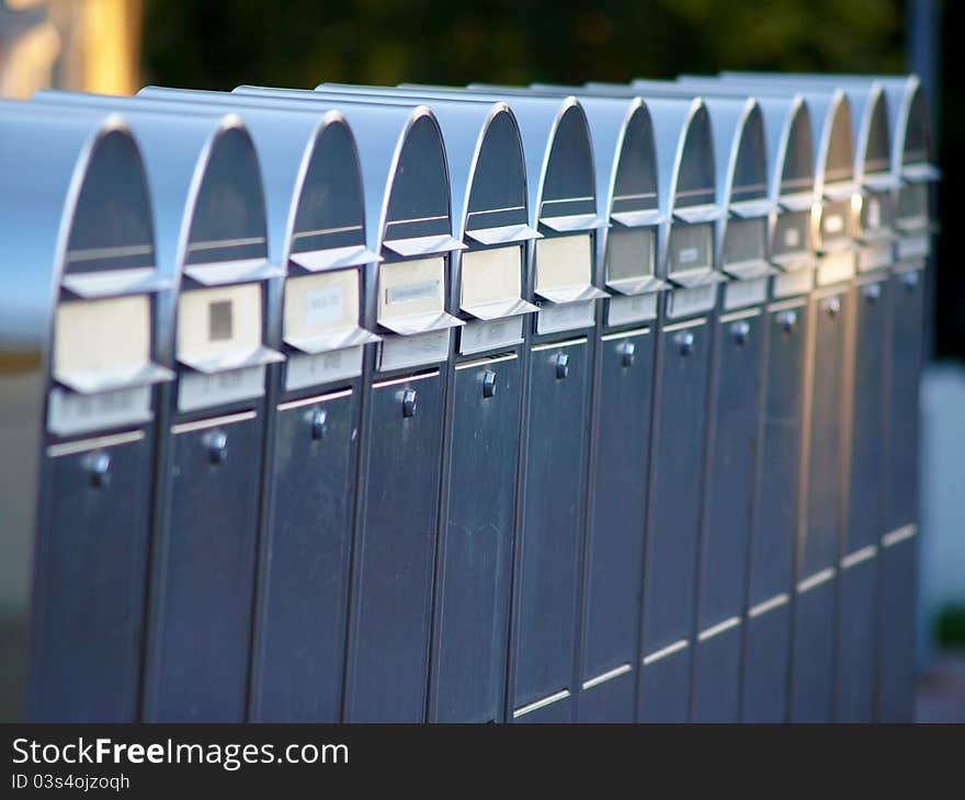 Shiny silver colored postboxes on line, in Finland