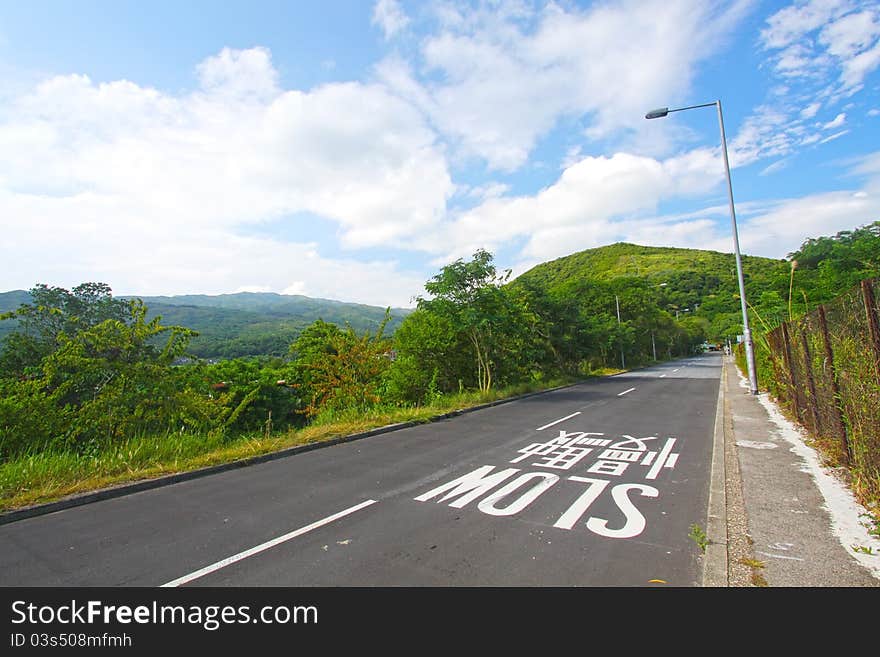 Road Against The Blue Sky With White Clouds