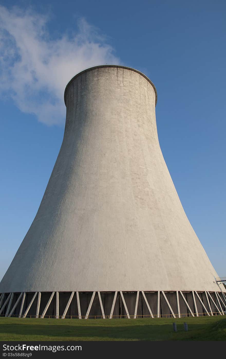 Cooling tower in power plant. Blue sky in background.