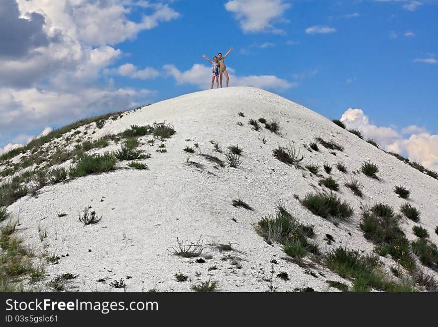 Two girls on a hilltop.