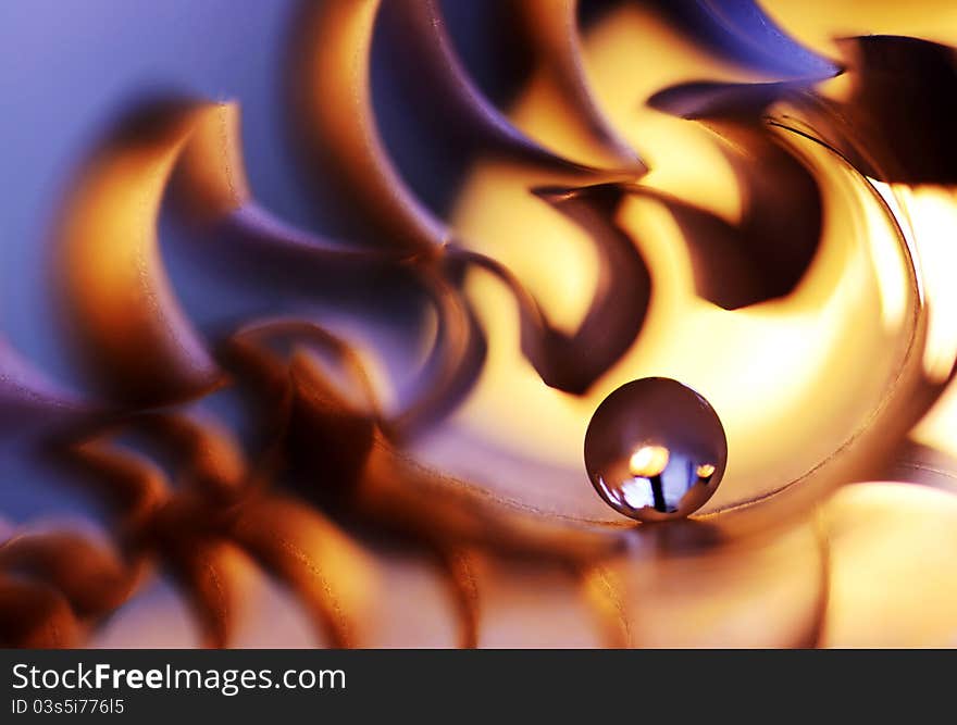 A glass marble on fire from paper. A glass marble on fire from paper