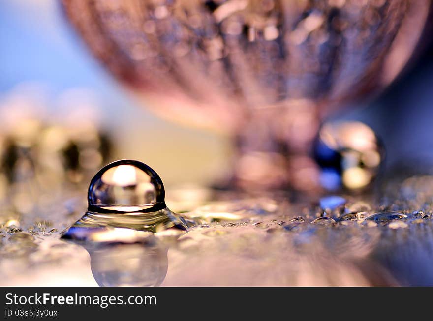 Wet glass marble and a pink bottle. Wet glass marble and a pink bottle