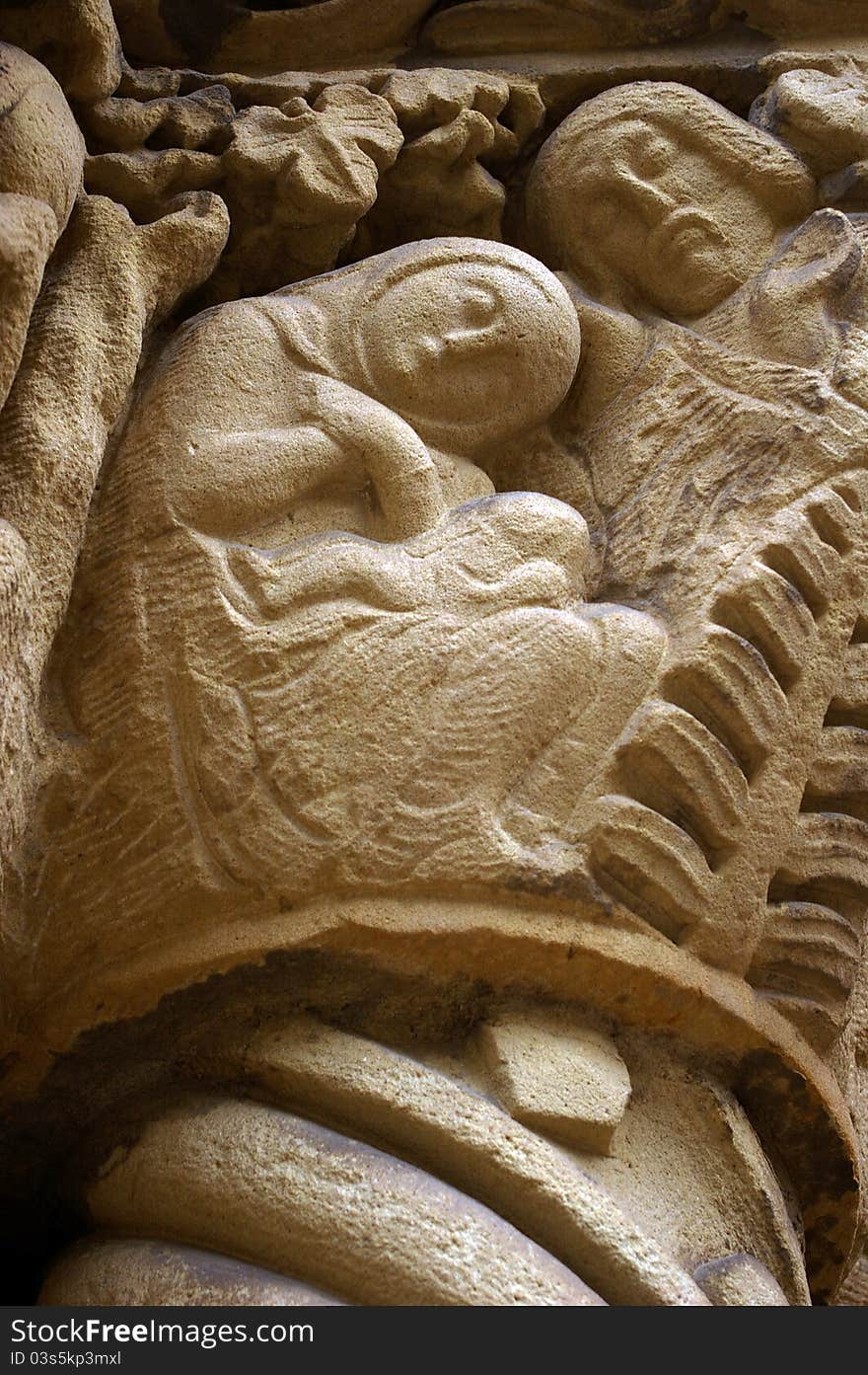 Naïf stone sculpture of the Holy family on the facade of a christian church in Spain. Naïf stone sculpture of the Holy family on the facade of a christian church in Spain.