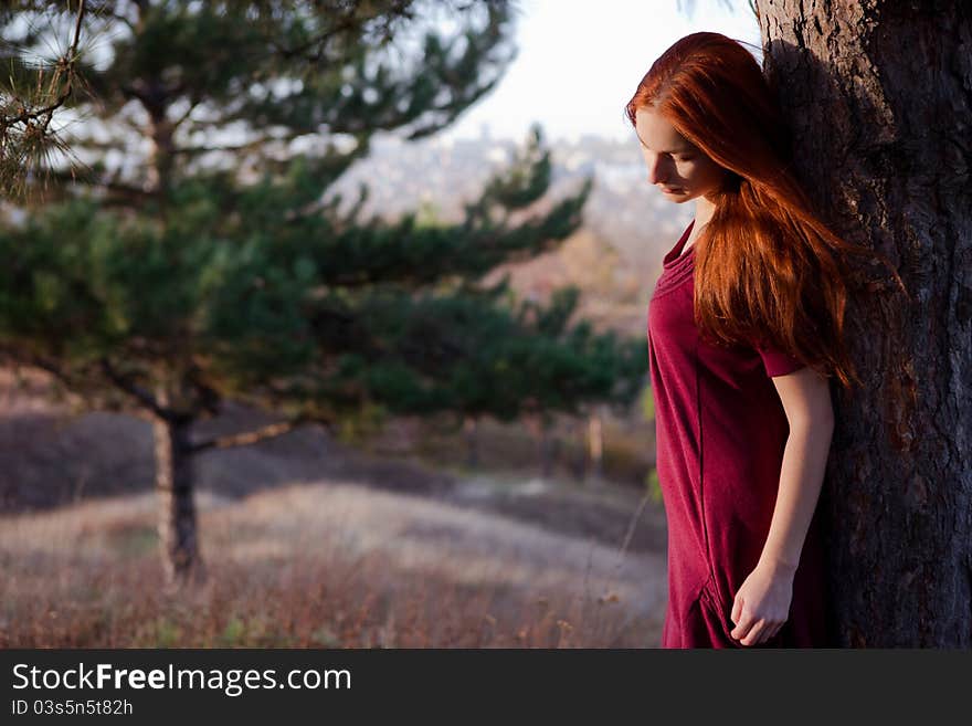 Portrait of a beautiful redhead girl in the spring garden. Portrait of a beautiful redhead girl in the spring garden