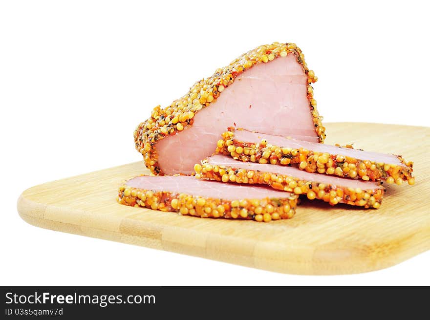 Piece of a ham with spices on a wooden board