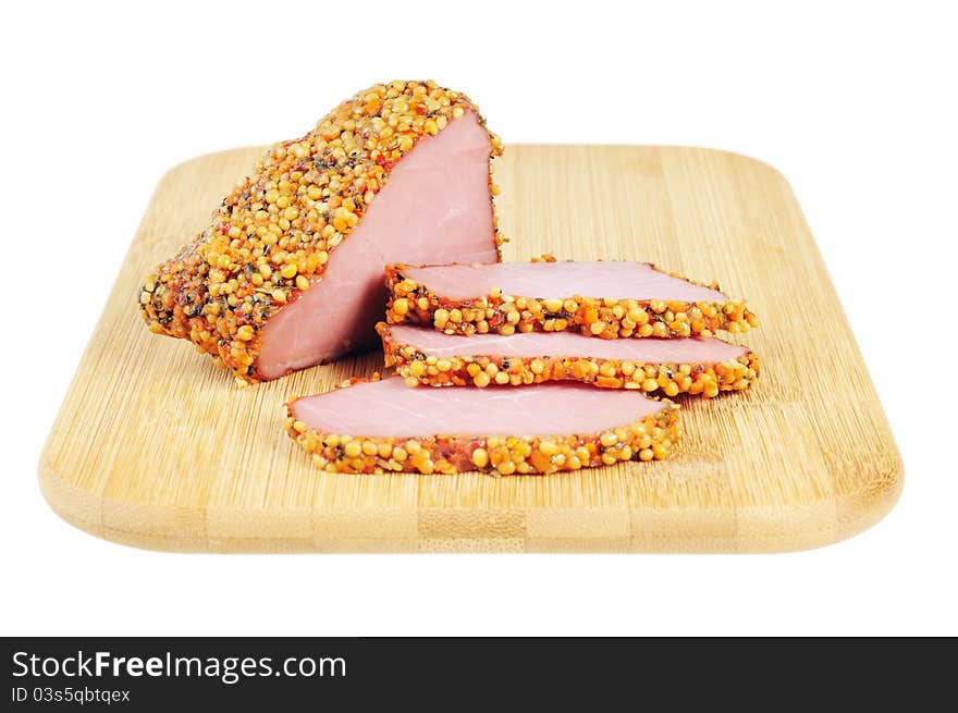 Piece of a ham with spices on a wooden board