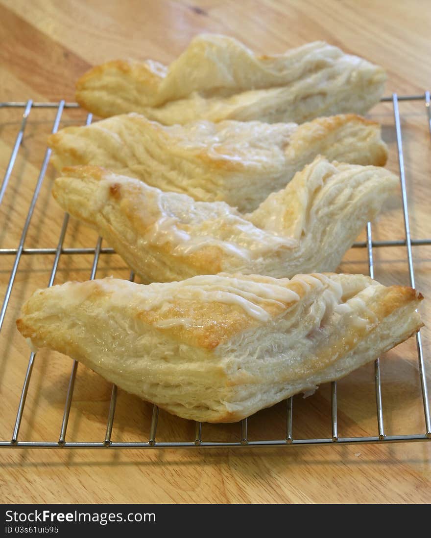 Fresh baked turnovers cooling on a cooling rack. Fresh baked turnovers cooling on a cooling rack