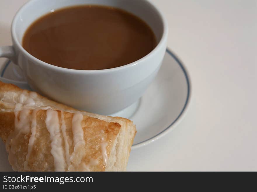 Coffee and pastry on white