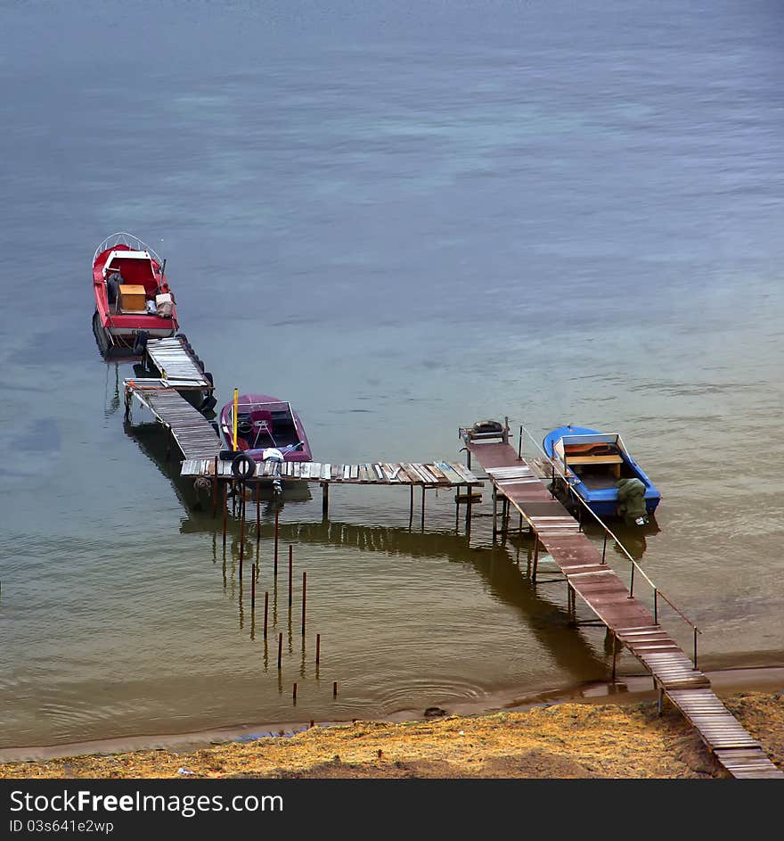 Three fishing boats in  blue waterway