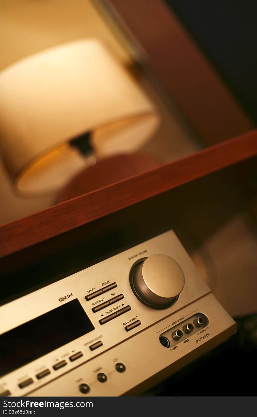 Hi-fi amplifier detail in cozy living room  with natural light wit lamp in background