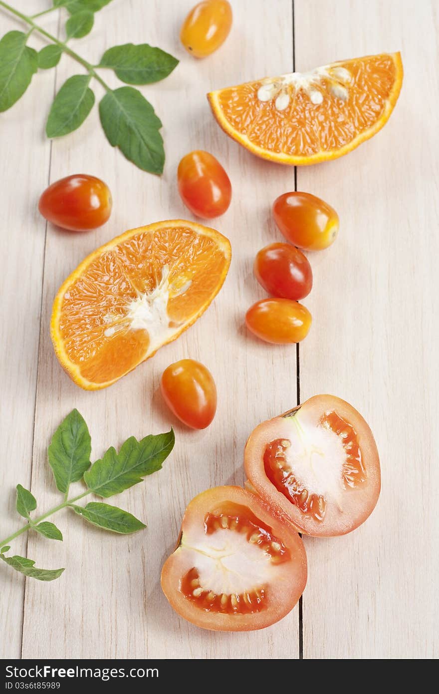 Tomato vegetable with orange fruit  on table