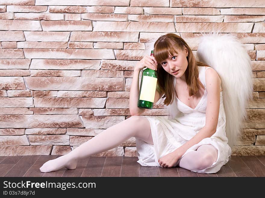 Angel Girl On Brick Wall With A Bottle