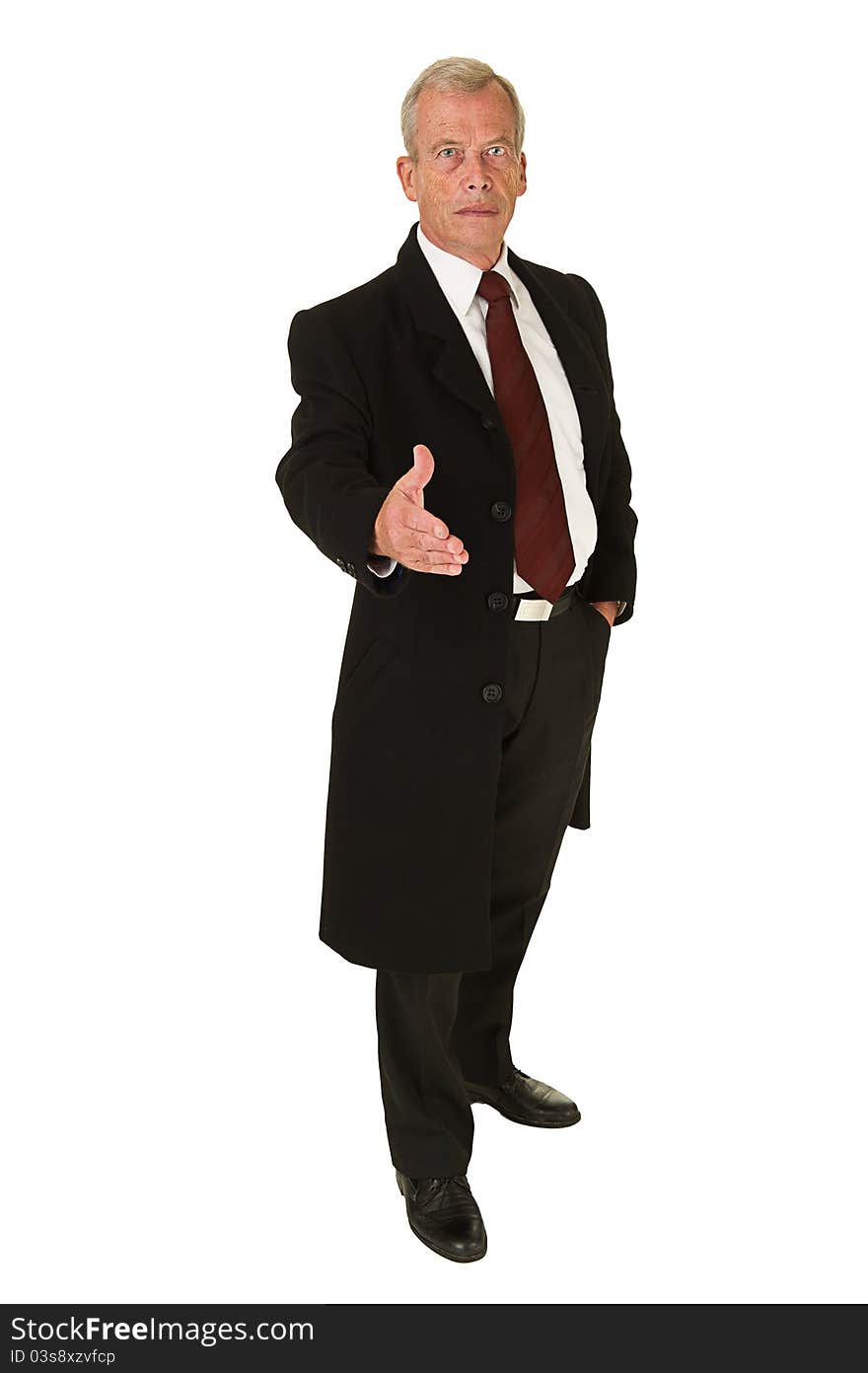 Business man in black suit holding hand out for greeting over a white background. Business man in black suit holding hand out for greeting over a white background