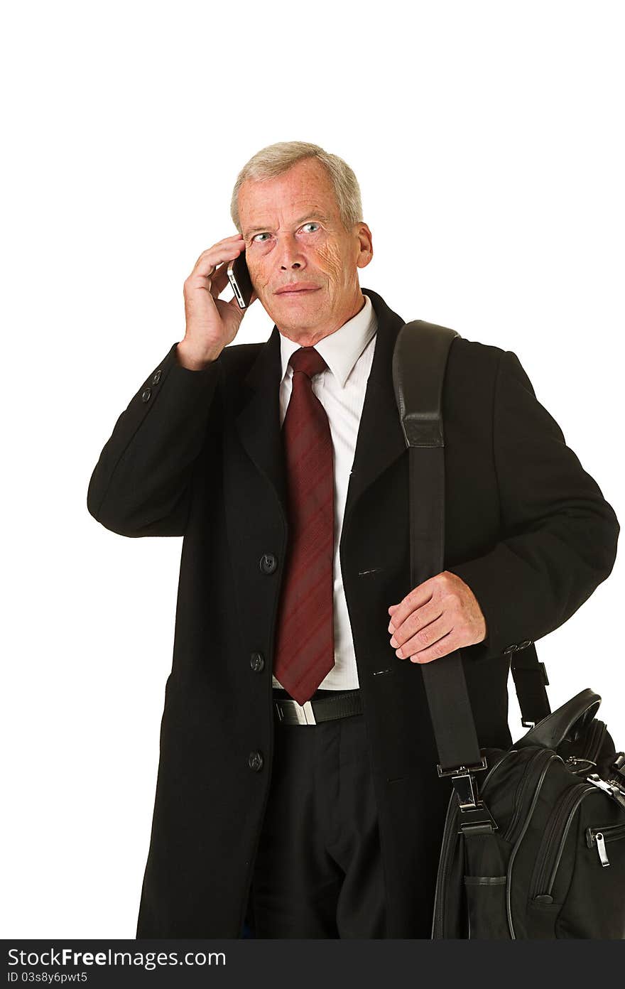 Business man in black suit talking on the phone while on the go. Over a white background. Business man in black suit talking on the phone while on the go. Over a white background