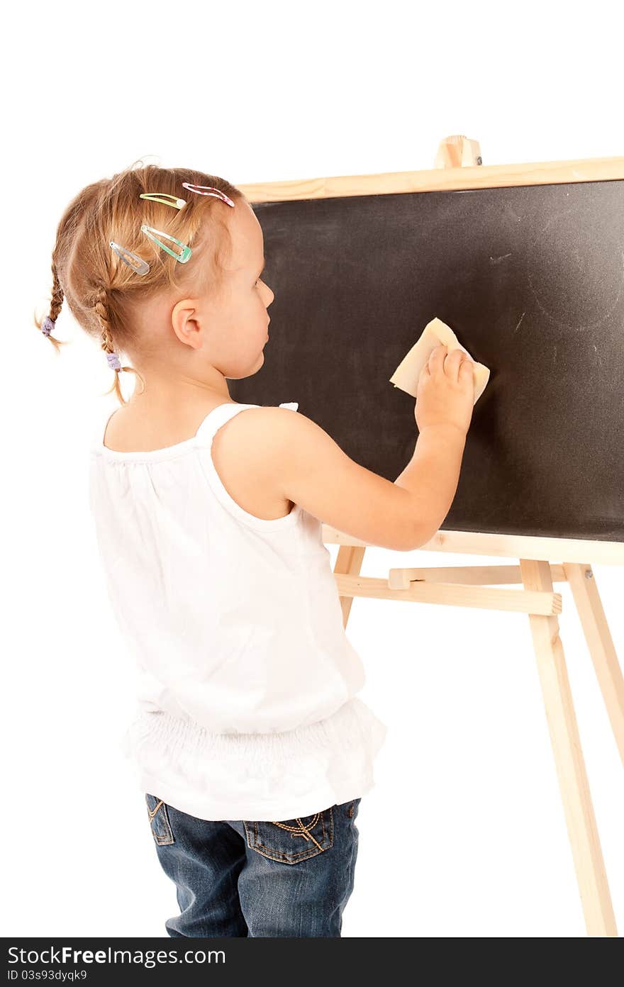 Little girl standing at the blackboard