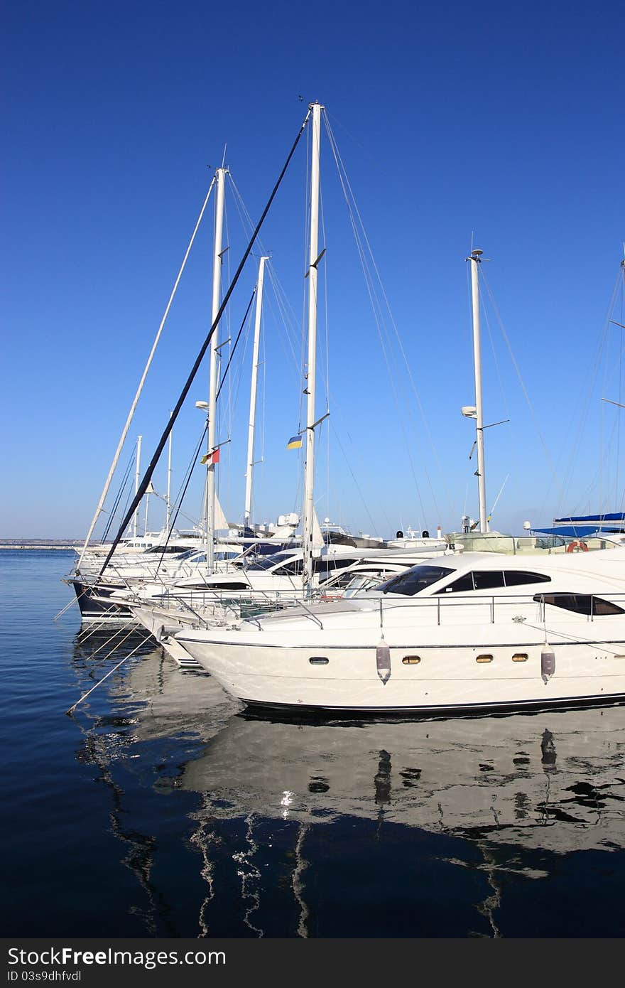 White yachts in row mooring in marina. White yachts in row mooring in marina