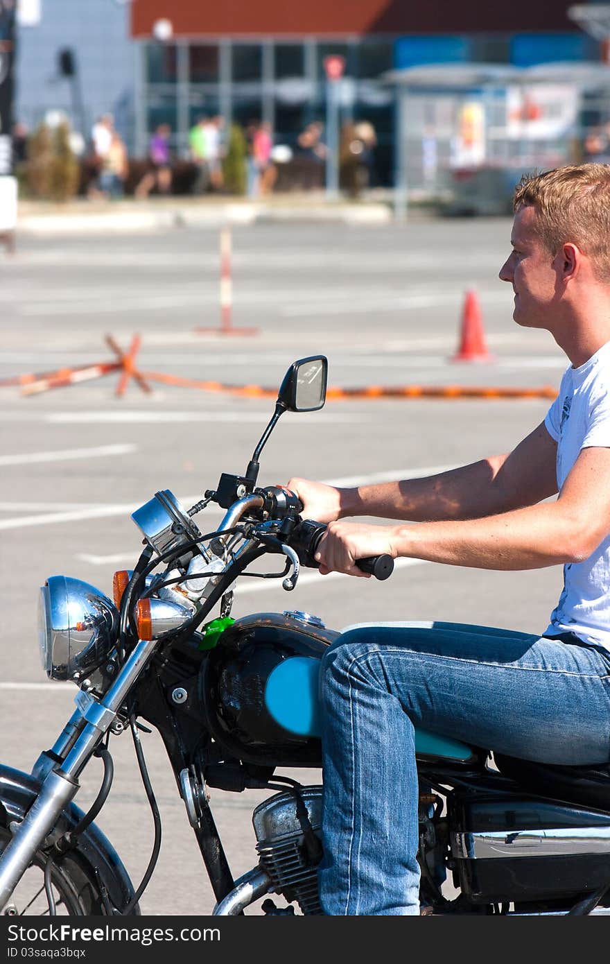 Young man learning to drive a motorbike. Young man learning to drive a motorbike