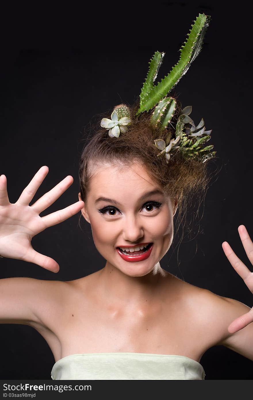 Woman with cactus in her hair on a black background. Woman with cactus in her hair on a black background