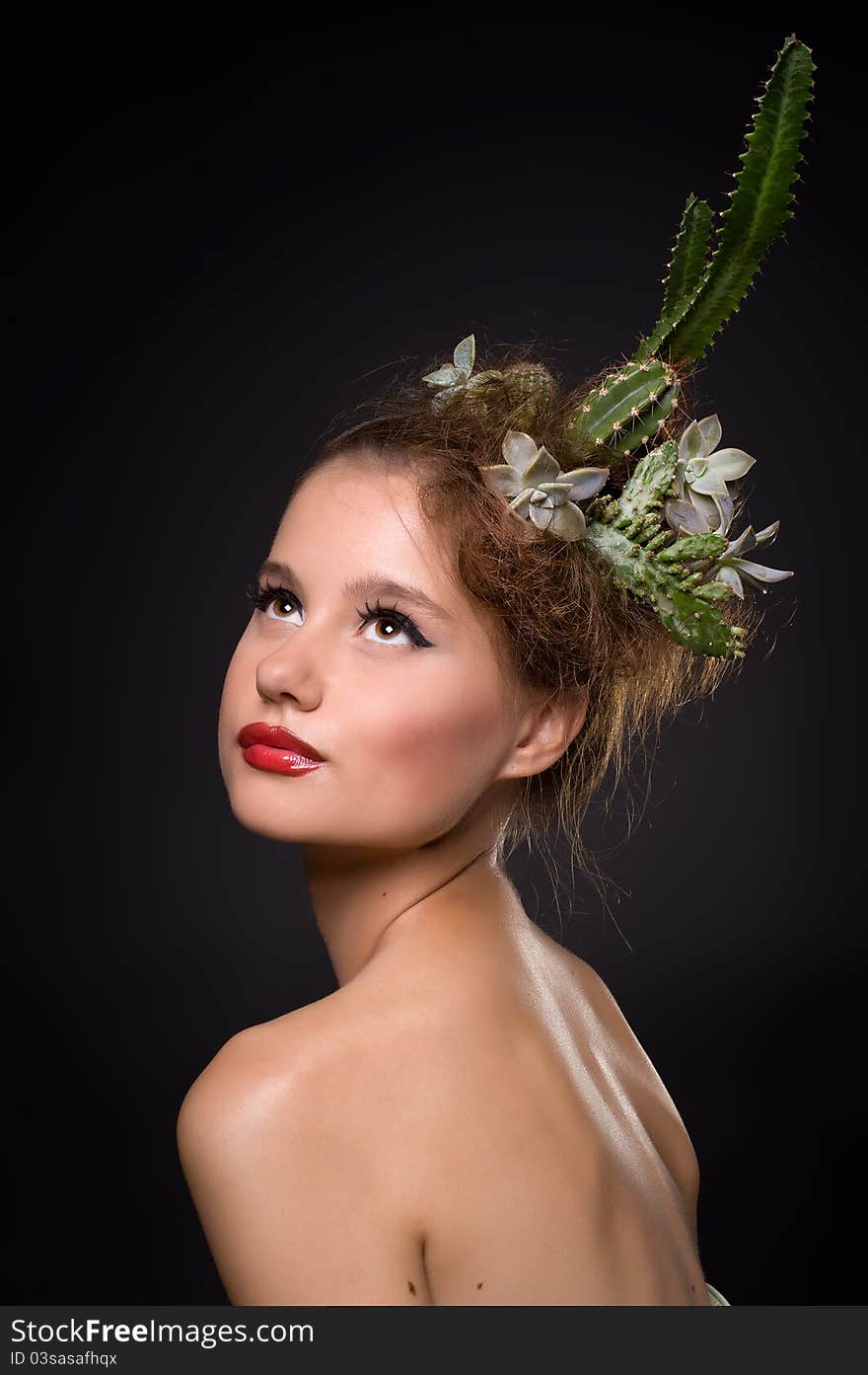 Woman with cactus in her hair on a black background