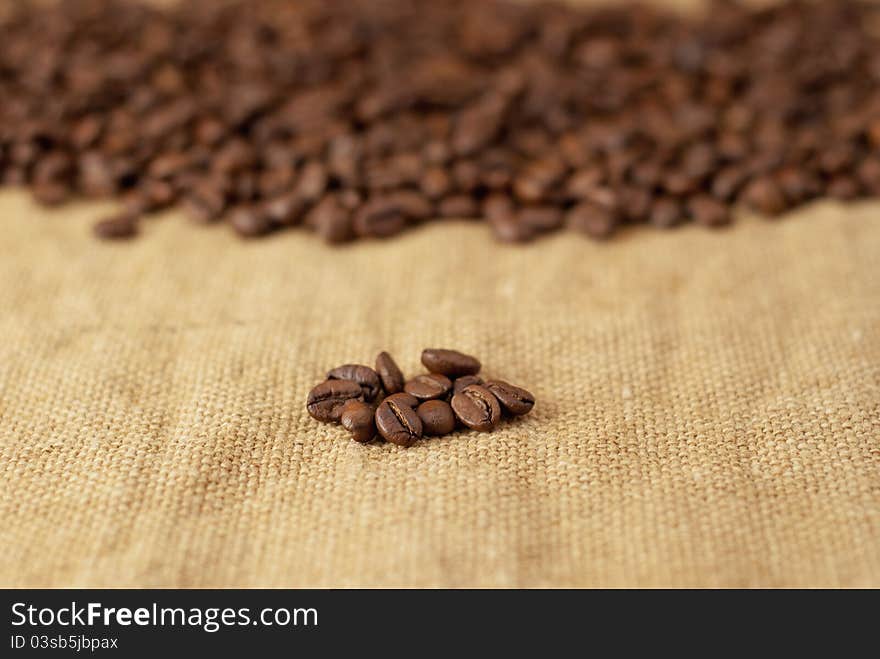 Freshly roasted coffee beans on burlap