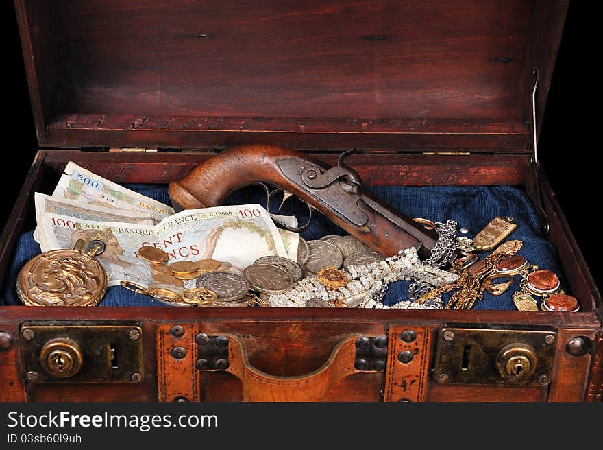 A trunk full of coins and precious jewelry. A trunk full of coins and precious jewelry