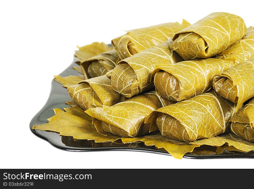 Dolma on a black plate. Isolated on white background. Dolma on a black plate. Isolated on white background.