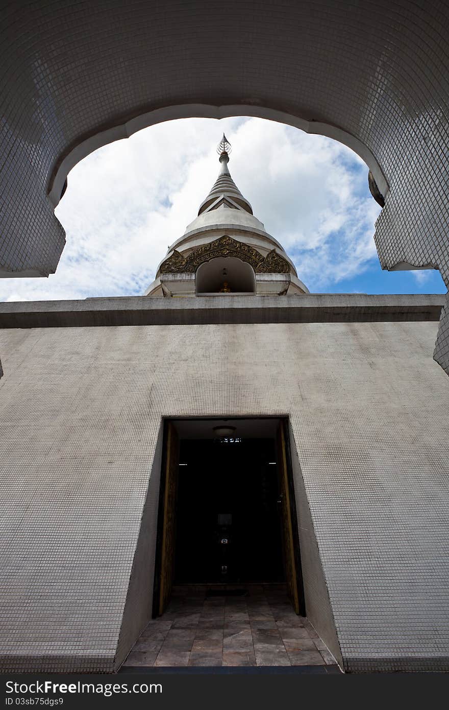 White pagoda in Wat Phra That Pha Ngao on blue sky background