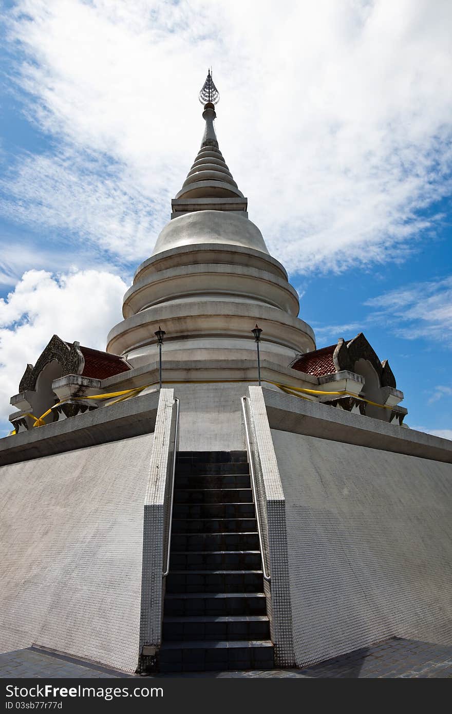 White pagoda in Wat Phra That Pha Ngao on blue sky background