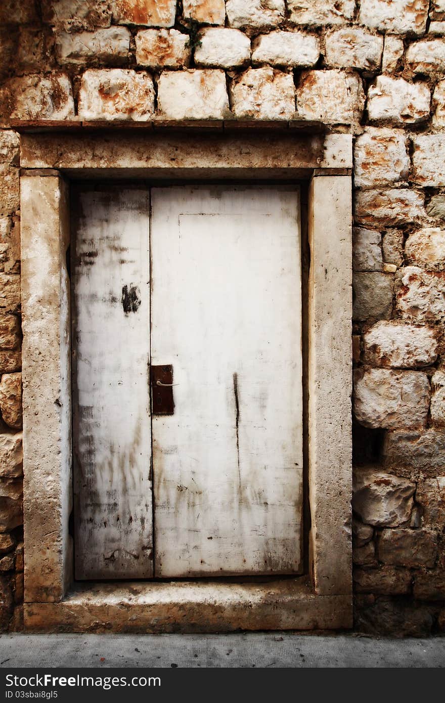 Old wooden door in a stone wall