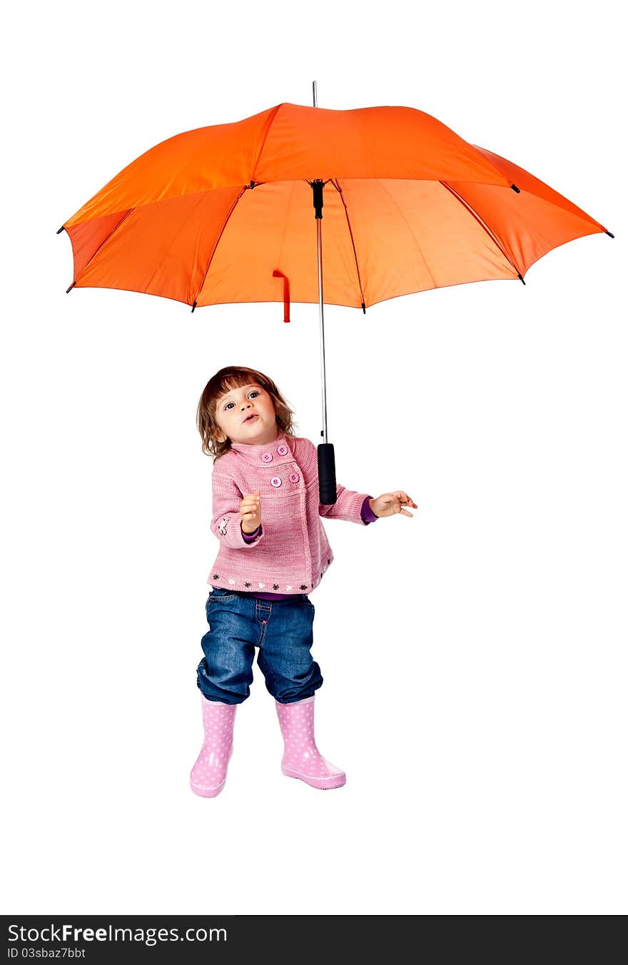 Little girl with an orange umbrella in the studio