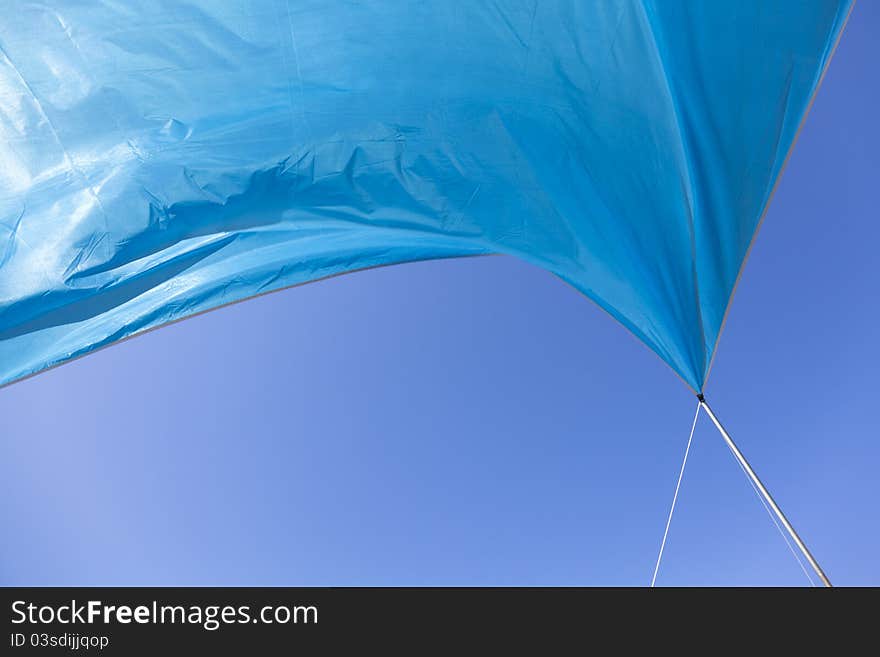 Blue tent waving in the blue sky