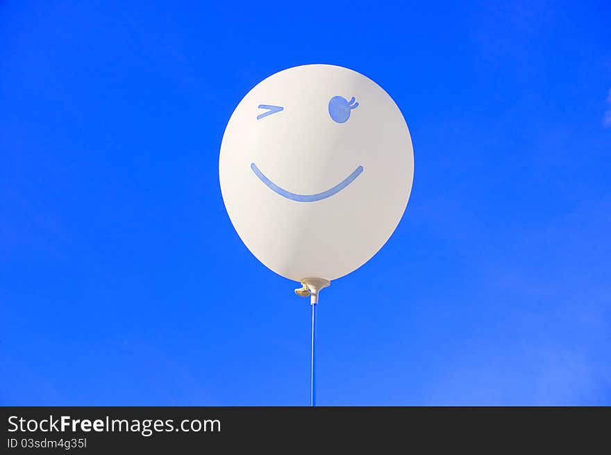 A smilling balloon isolated on blue