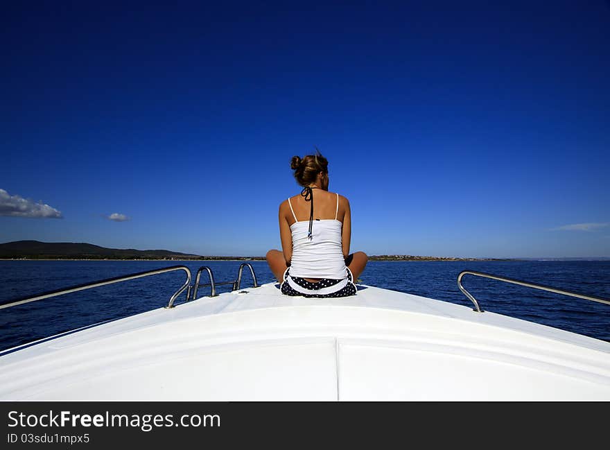 Young woman looking at sea on board the boat