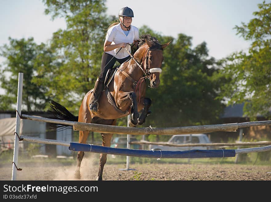 Show jumping.girl riding horse and jumping