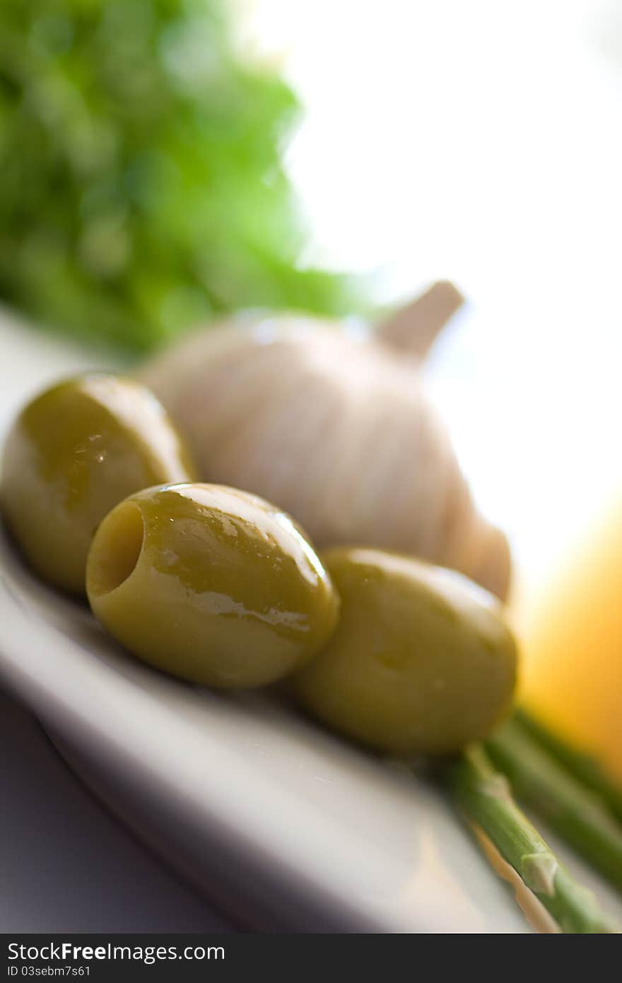 Close up for onion cheese olive and asparagus on a white plate and white background. Close up for onion cheese olive and asparagus on a white plate and white background