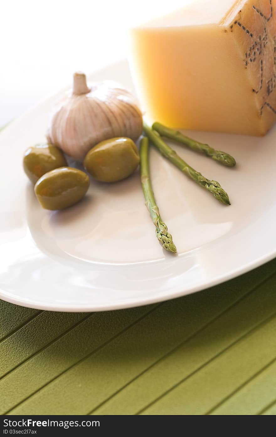 Close up for onion cheese olive and asparagus on a white plate and white background. Close up for onion cheese olive and asparagus on a white plate and white background