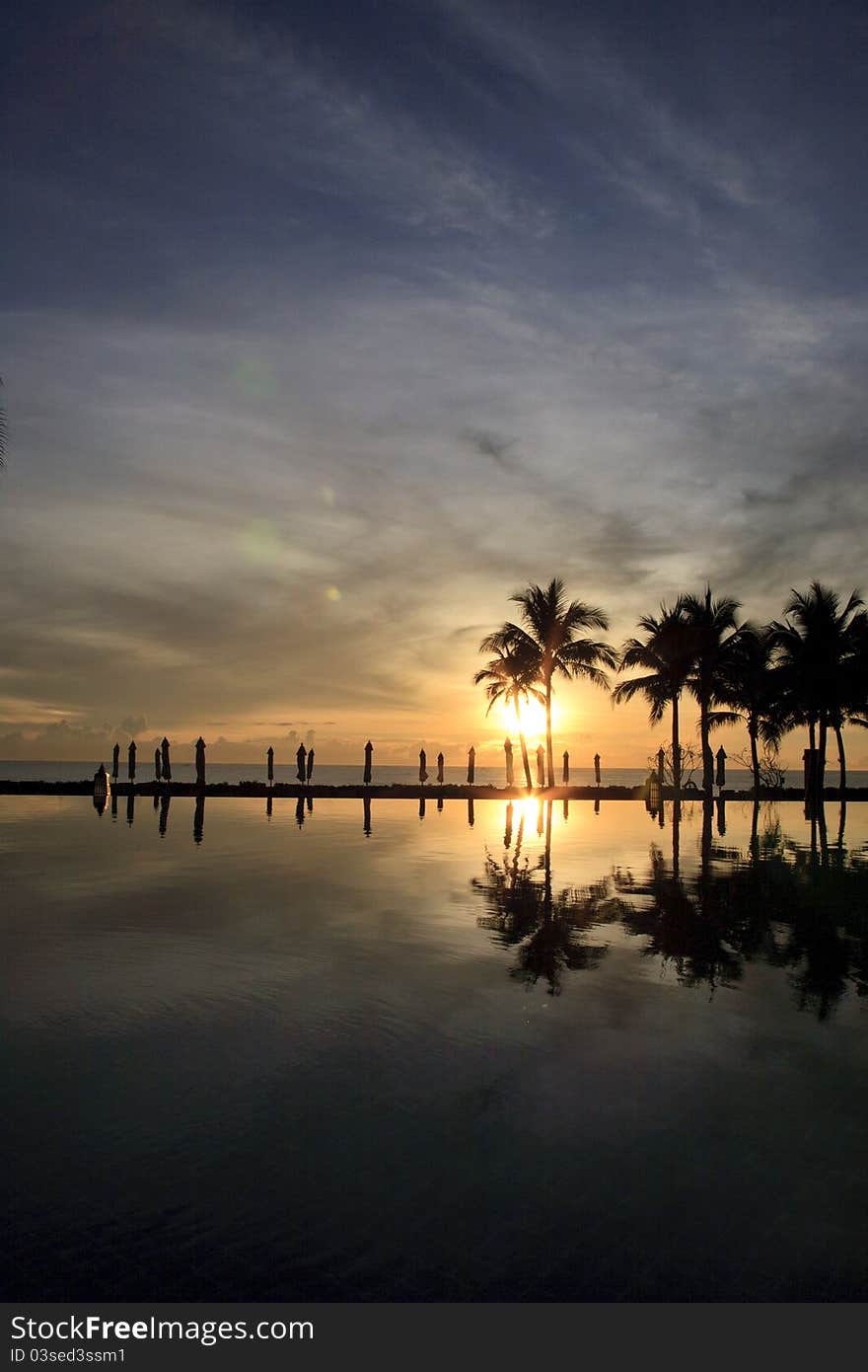 Pool and beach taking while sunset in the morning. Pool and beach taking while sunset in the morning