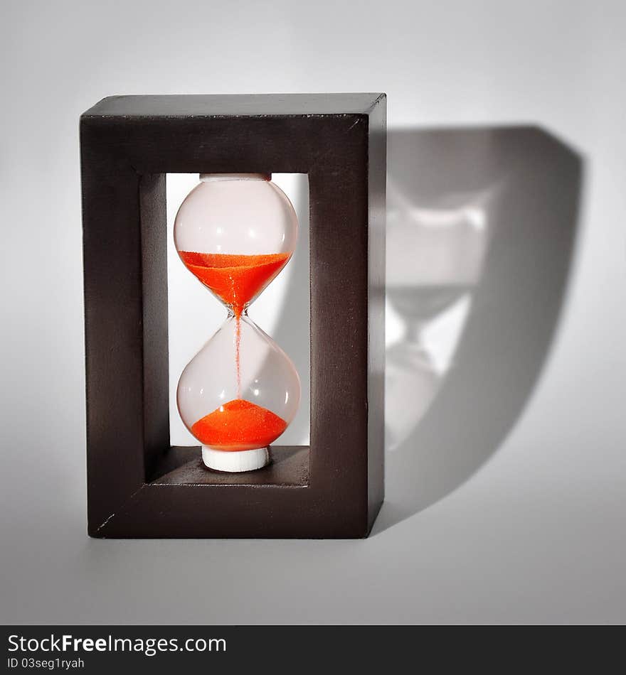 Sand-glass on white background with shadow