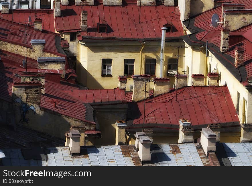 Old houses with red metal roofs. Old houses with red metal roofs