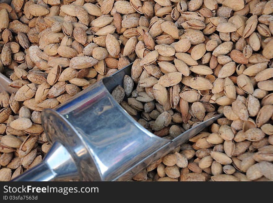 Unshelled Almonds and Metal Scoop