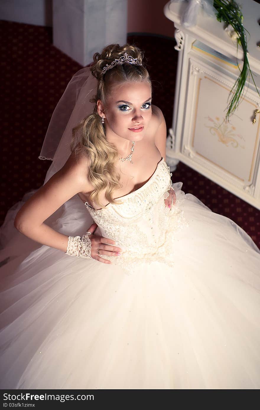 Portrait of cute young bride wearing the white via