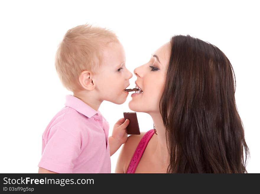 Happy family of son feed his mother chocolate bar. Happy family of son feed his mother chocolate bar