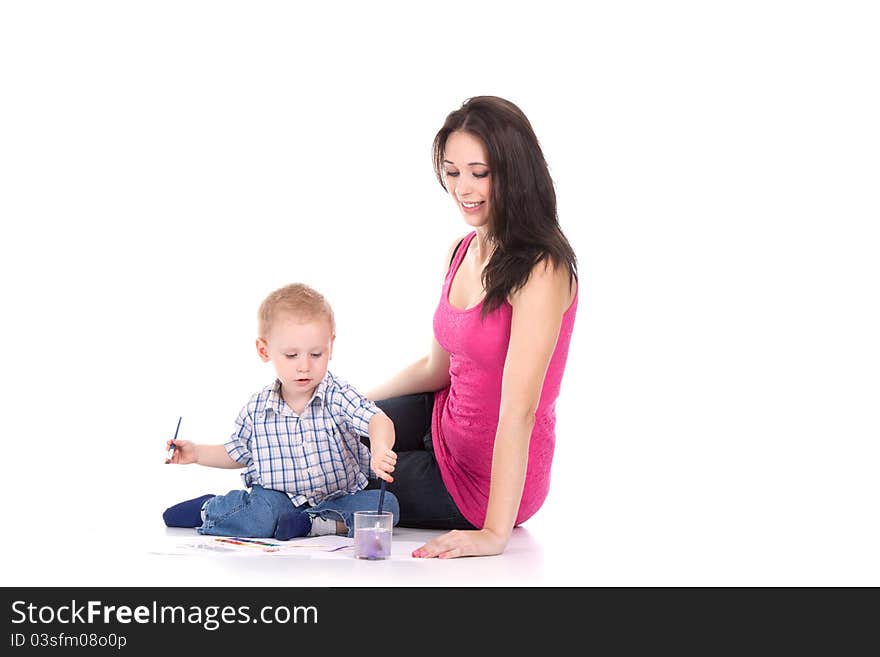 Happy young mother and son painting over white. Happy young mother and son painting over white