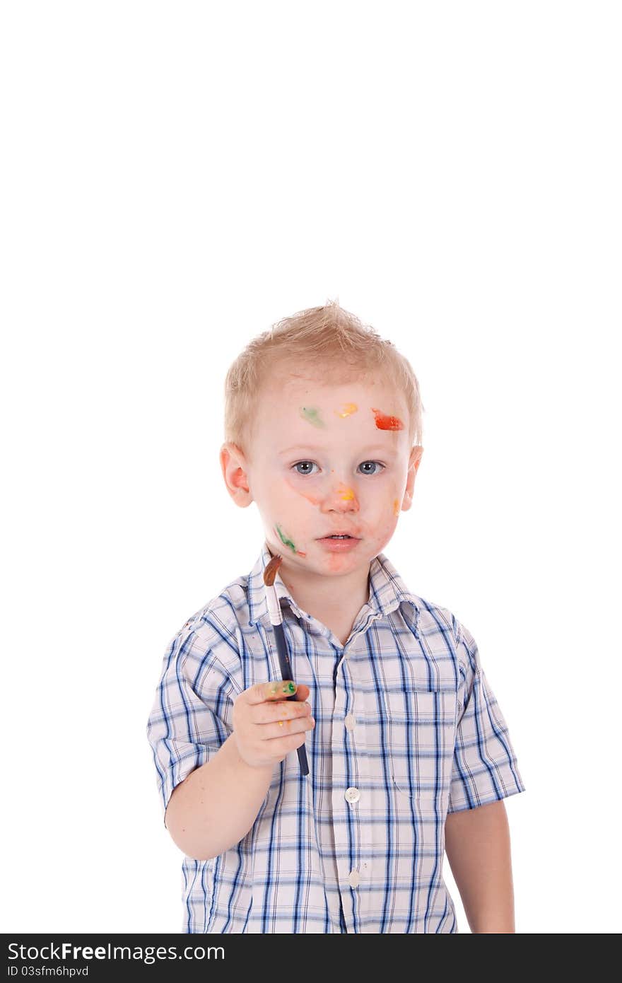 2 year old boy covered in paint. Holding brush. 2 year old boy covered in paint. Holding brush