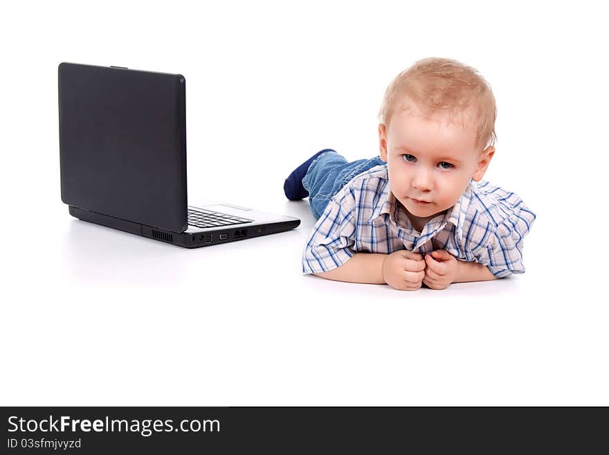 Little boy sitting with laptop over white background