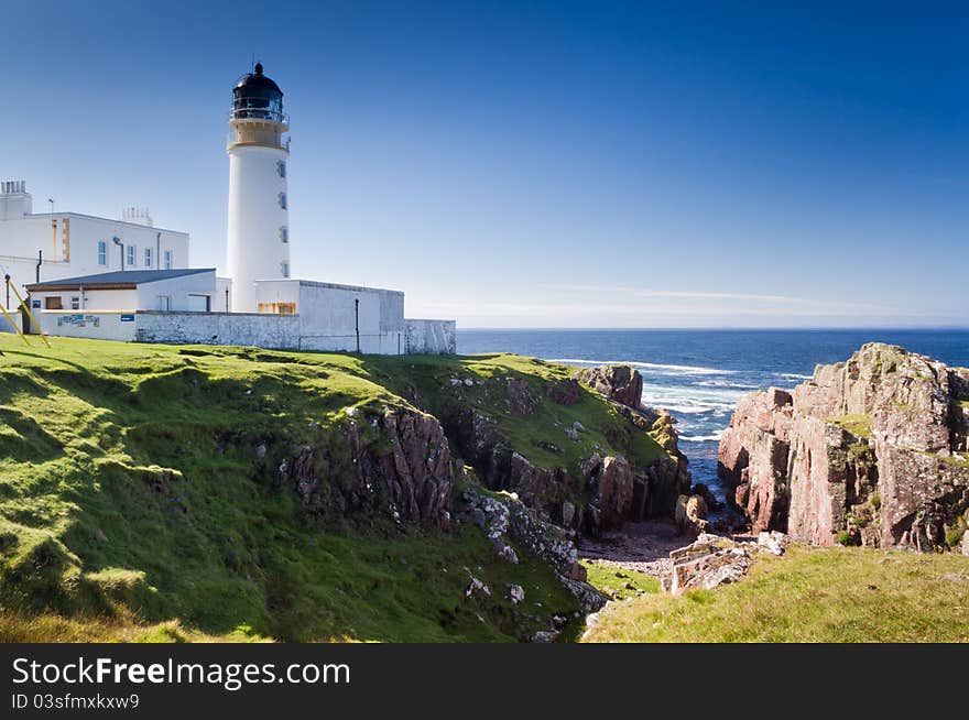 Lighthouse on rocks and deep crevice leading to sea. Lighthouse on rocks and deep crevice leading to sea