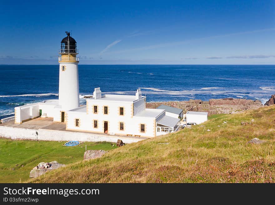 Lighthouse from above with sunny sea and sky behind. Lighthouse from above with sunny sea and sky behind